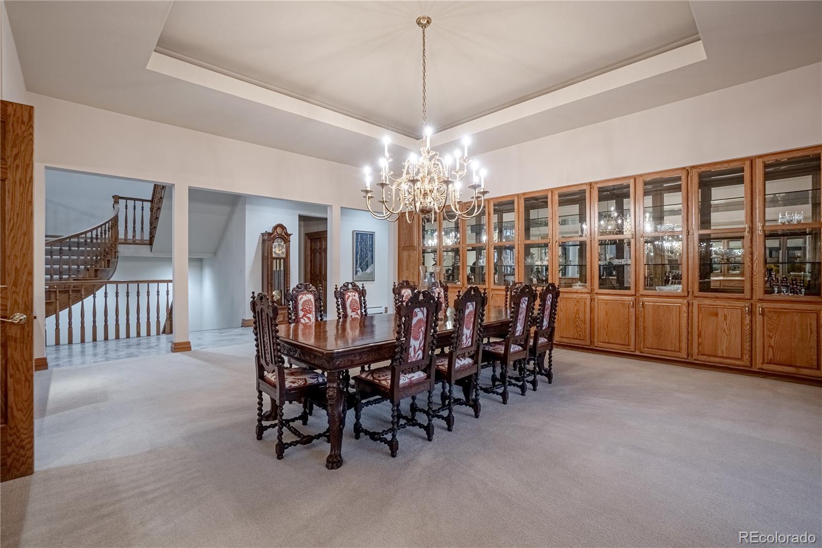 3282 Tomah Road Larkspur, CO 80118 - Photo 12 of 35 a dining room with furniture a chandelier and window
