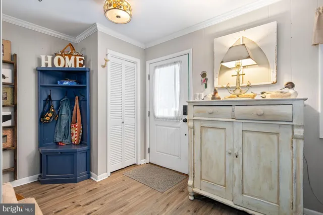 a view of a hallway a bedroom with wooden floor and closet