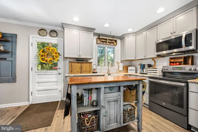 a kitchen with stainless steel appliances granite countertop a stove and a sink