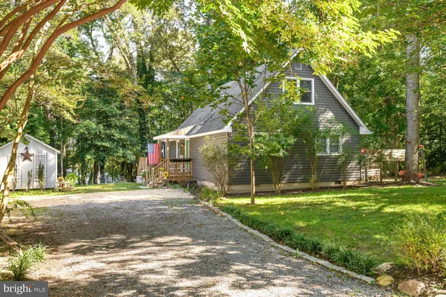 a backyard of a house with swimming pool and large trees