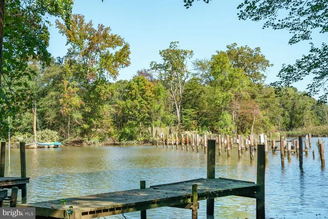 a small pool with lawn chairs and a trees