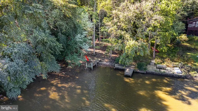 an aerial view of a houses with a lake view