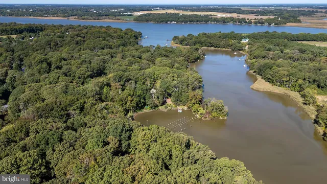 an aerial view of a houses with a lake view