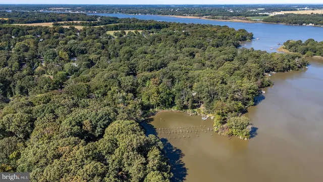 an aerial view of a houses with ocean view