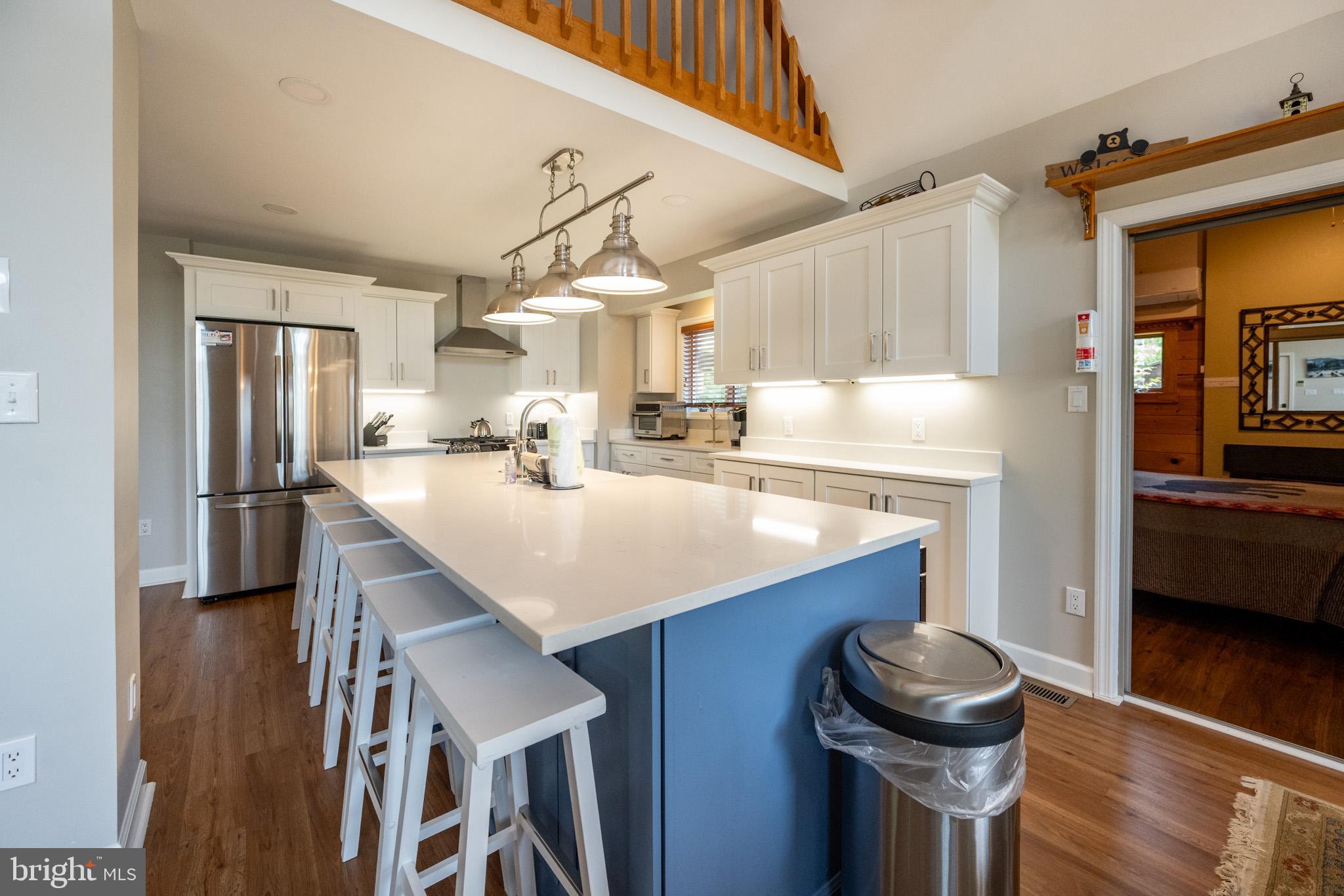 201 Rock Lodge Road McHenry, MD 21541 - Photo 11 of 75 a kitchen with kitchen island a sink appliances a counter space and a window