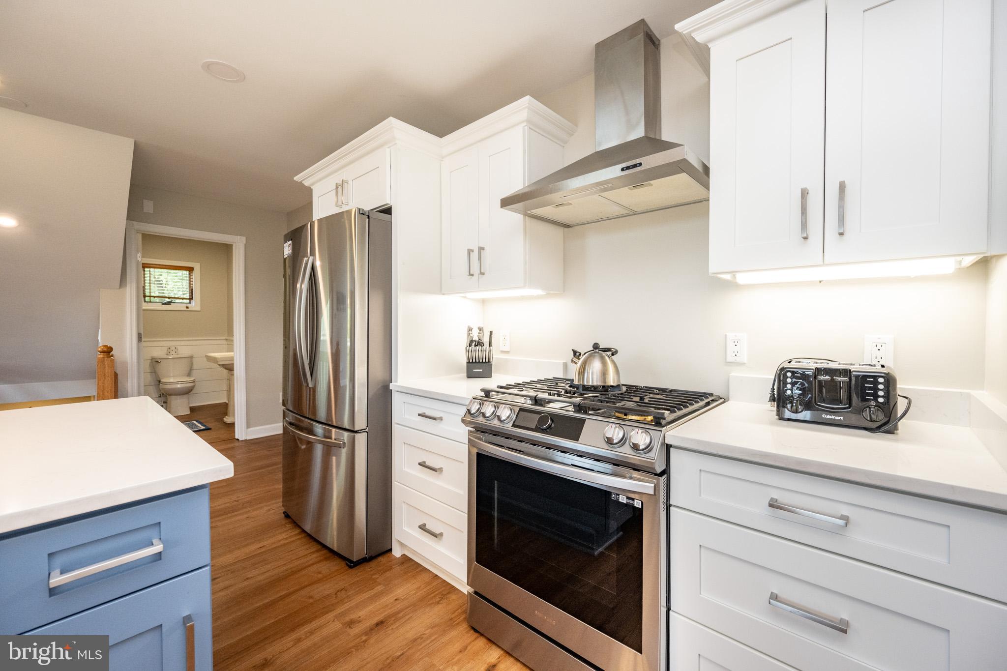201 Rock Lodge Road McHenry, MD 21541 - Photo 14 of 75 a kitchen with stainless steel appliances granite countertop a stove and a refrigerator
