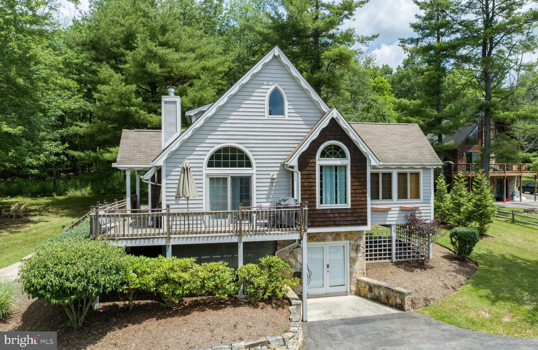 201 Rock Lodge Road McHenry, MD 21541 - Photo 2 of 75 a view of house with a yard and potted plants