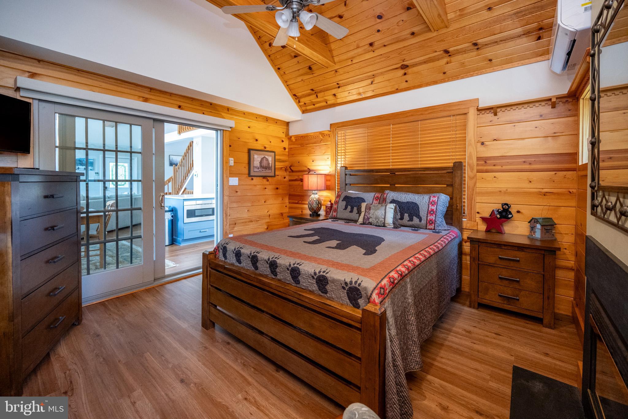 201 Rock Lodge Road McHenry, MD 21541 - Photo 22 of 75 a living room with hard wood floors and a bed