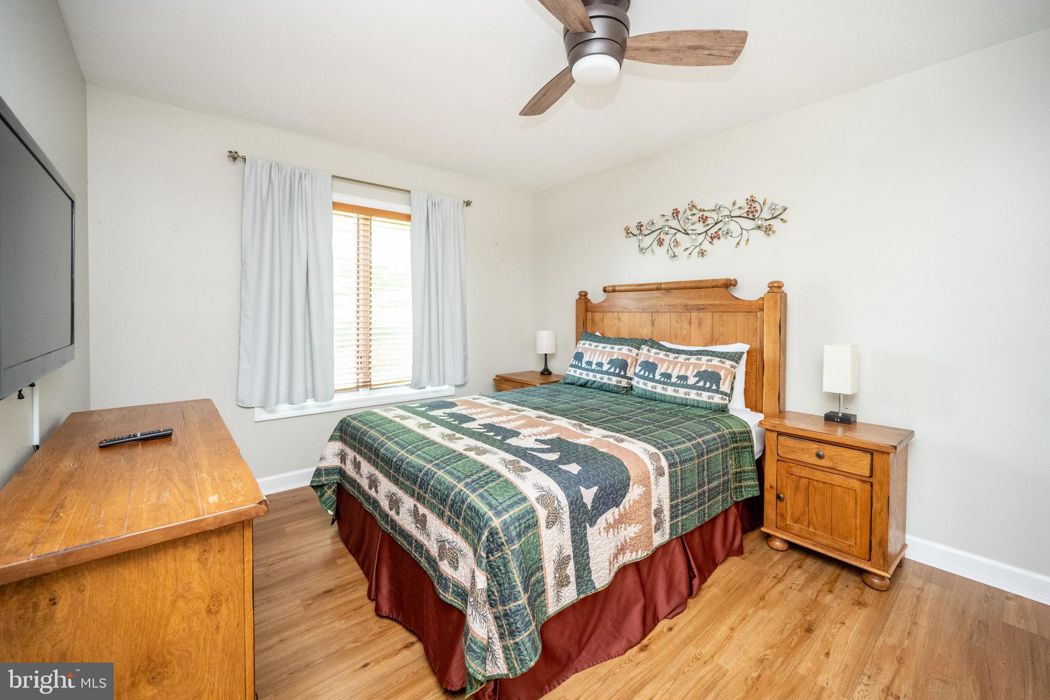 201 Rock Lodge Road McHenry, MD 21541 - Photo 28 of 75 a bedroom with a bed and wooden floor