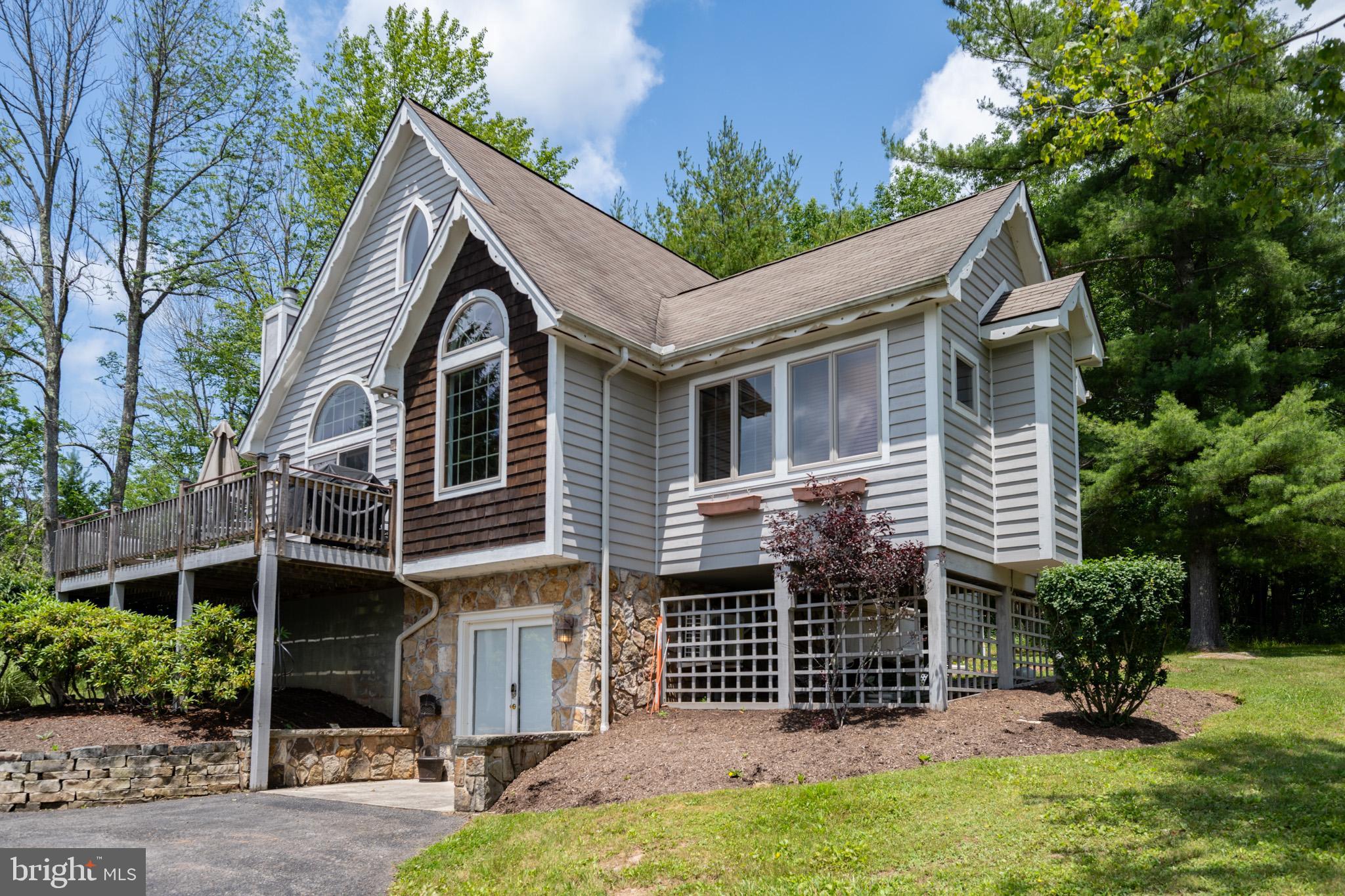 201 Rock Lodge Road McHenry, MD 21541 - Photo 3 of 75 a front view of a house with a garden