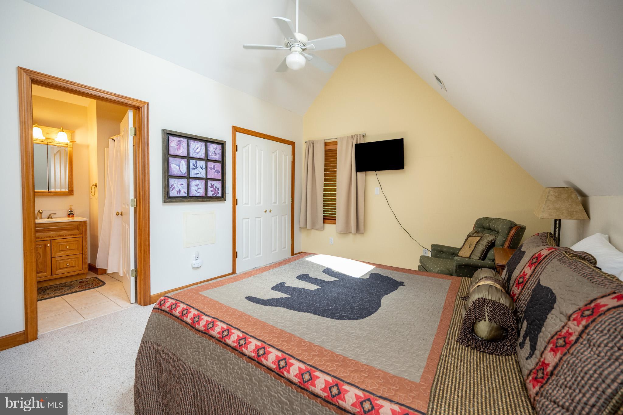 201 Rock Lodge Road McHenry, MD 21541 - Photo 35 of 75 a bedroom with a bed and a flat tv screen