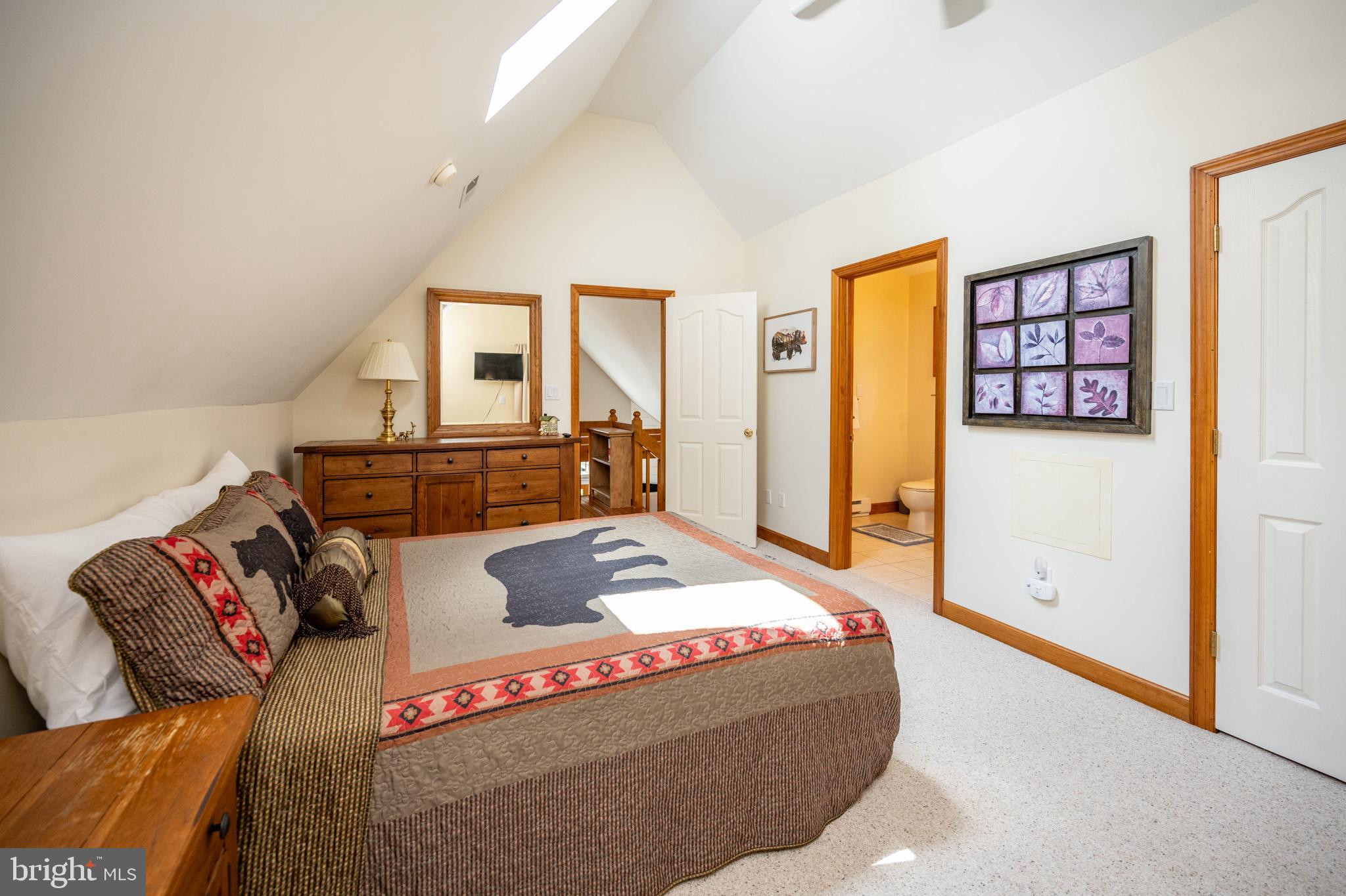 201 Rock Lodge Road McHenry, MD 21541 - Photo 38 of 75 a living room with a couch and a dresser next to a window