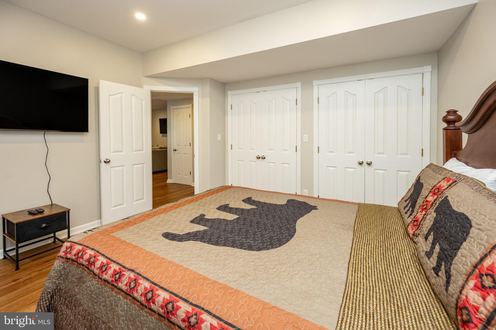 201 Rock Lodge Road McHenry, MD 21541 - Photo 51 of 75 a bedroom with a bed and a flat screen tv