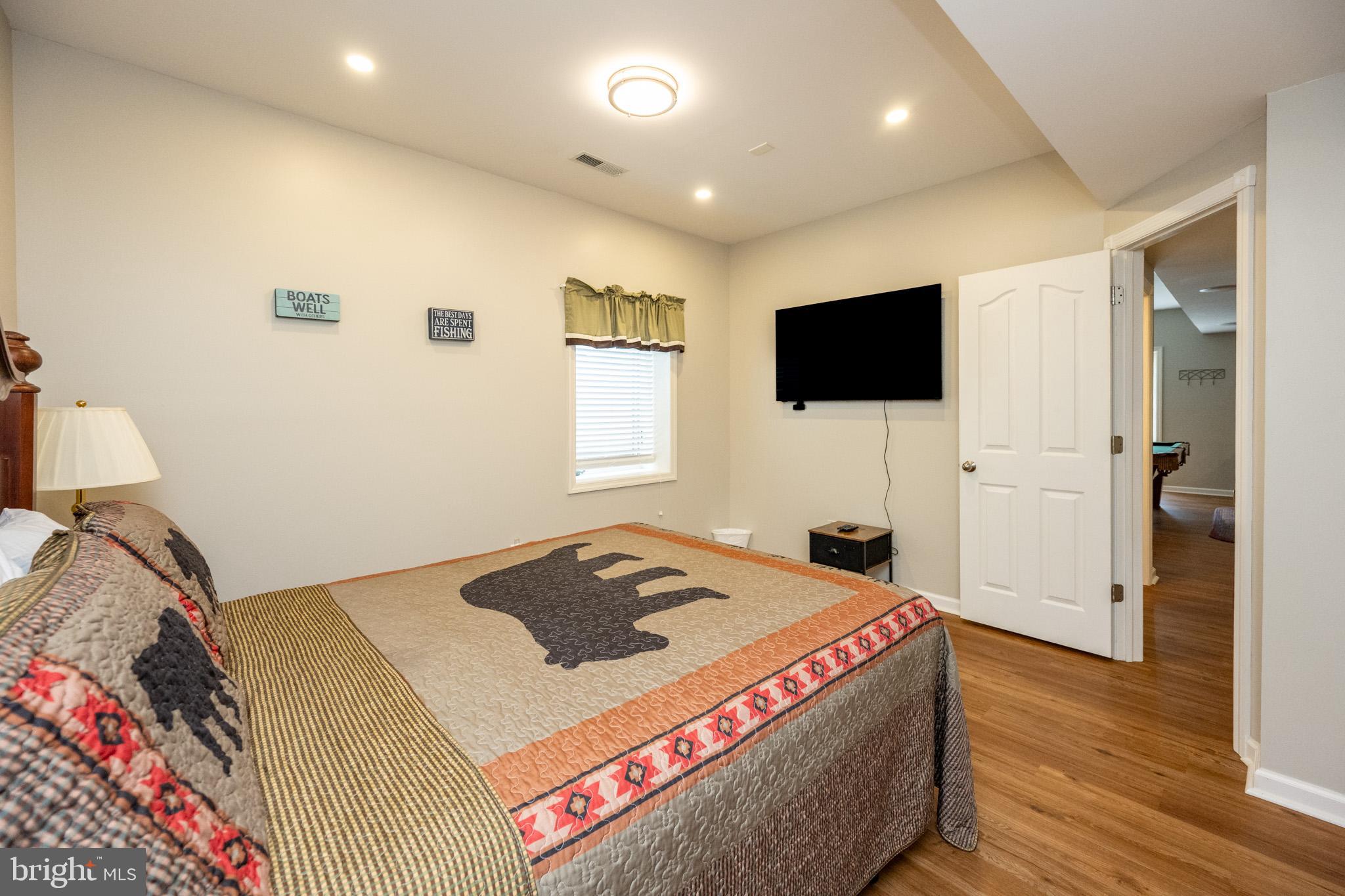 201 Rock Lodge Road McHenry, MD 21541 - Photo 52 of 75 a bedroom with a bed and a flat screen tv