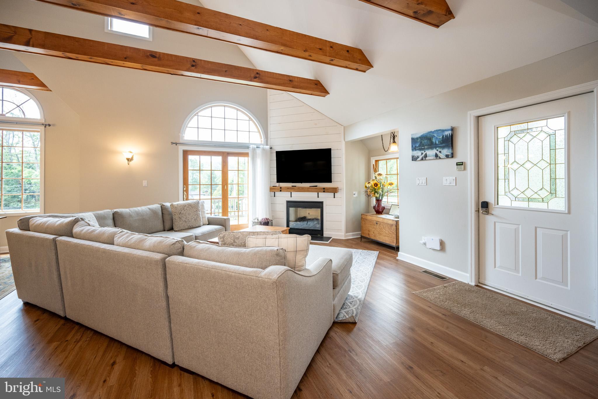 201 Rock Lodge Road McHenry, MD 21541 - Photo 10 of 75 a living room with furniture a fireplace and a flat screen tv