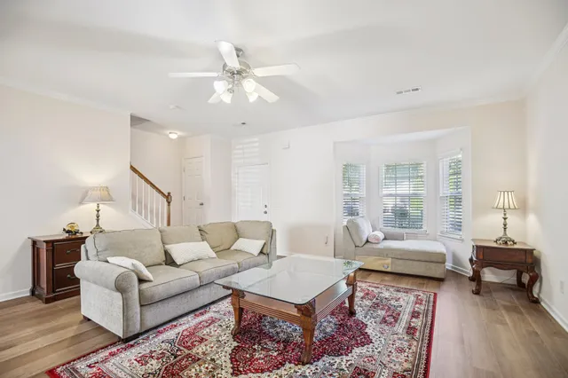 a living room with furniture and wooden floor