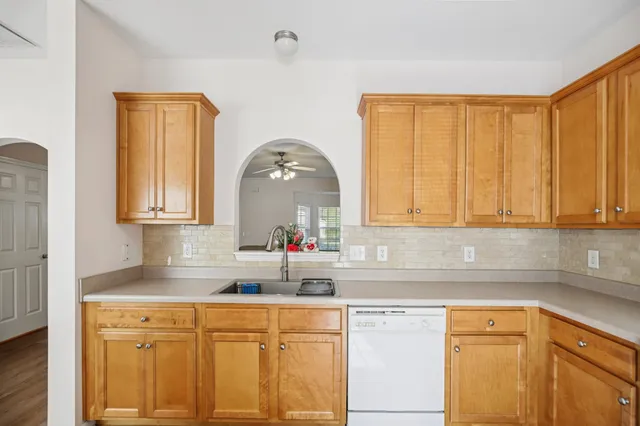 a kitchen with a sink cabinets and window