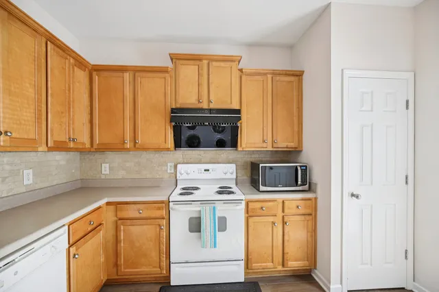 a kitchen with a stove top oven sink and cabinets