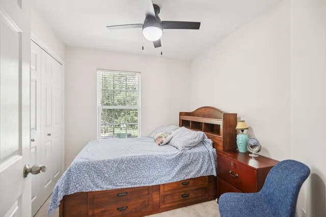 a bedroom with a bed and window