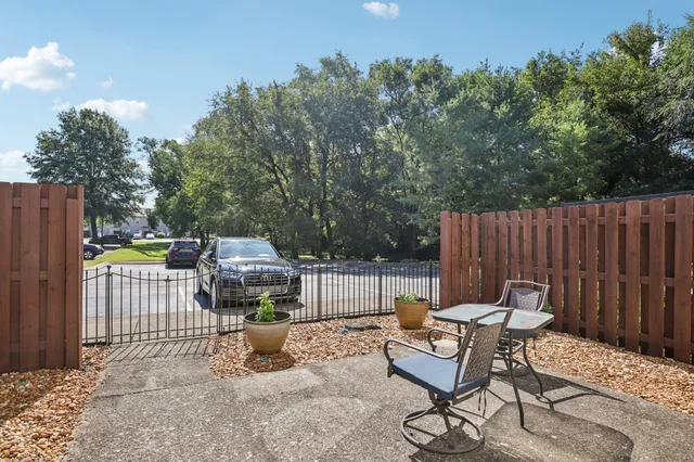 a view of a chairs and tables in the back yard of the house
