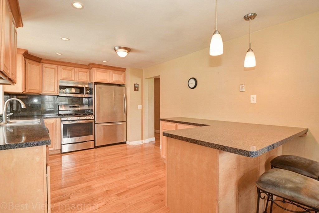59 Amor Road Milton, MA 02186 - Photo 11 of 29 a kitchen with stainless steel appliances a refrigerator and a stove top oven
