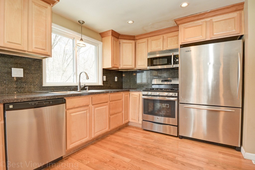59 Amor Road Milton, MA 02186 - Photo 12 of 29 a kitchen with stainless steel appliances a refrigerator sink and microwave