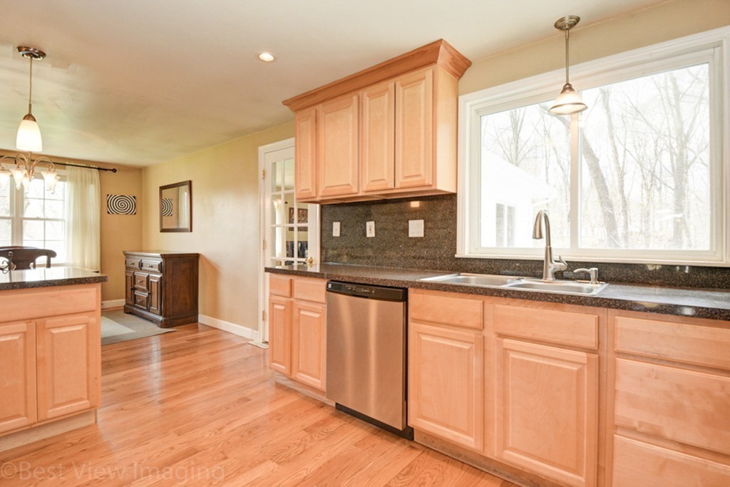 59 Amor Road Milton, MA 02186 - Photo 13 of 29 a kitchen with stainless steel appliances granite countertop a sink a stove and cabinets
