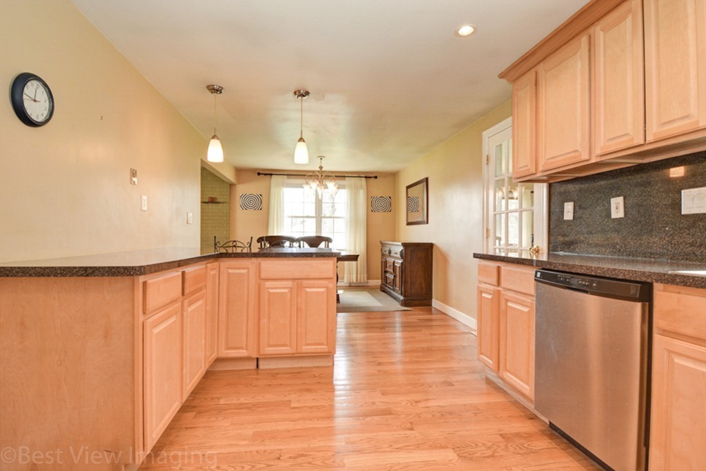 59 Amor Road Milton, MA 02186 - Photo 14 of 29 a view of a kitchen with kitchen island granite countertop a refrigerator stove top oven with a sink and dishwasher