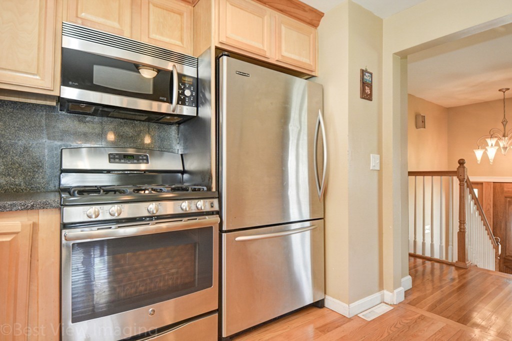 59 Amor Road Milton, MA 02186 - Photo 16 of 29 a kitchen with stainless steel appliances granite countertop a refrigerator microwave and stove top oven