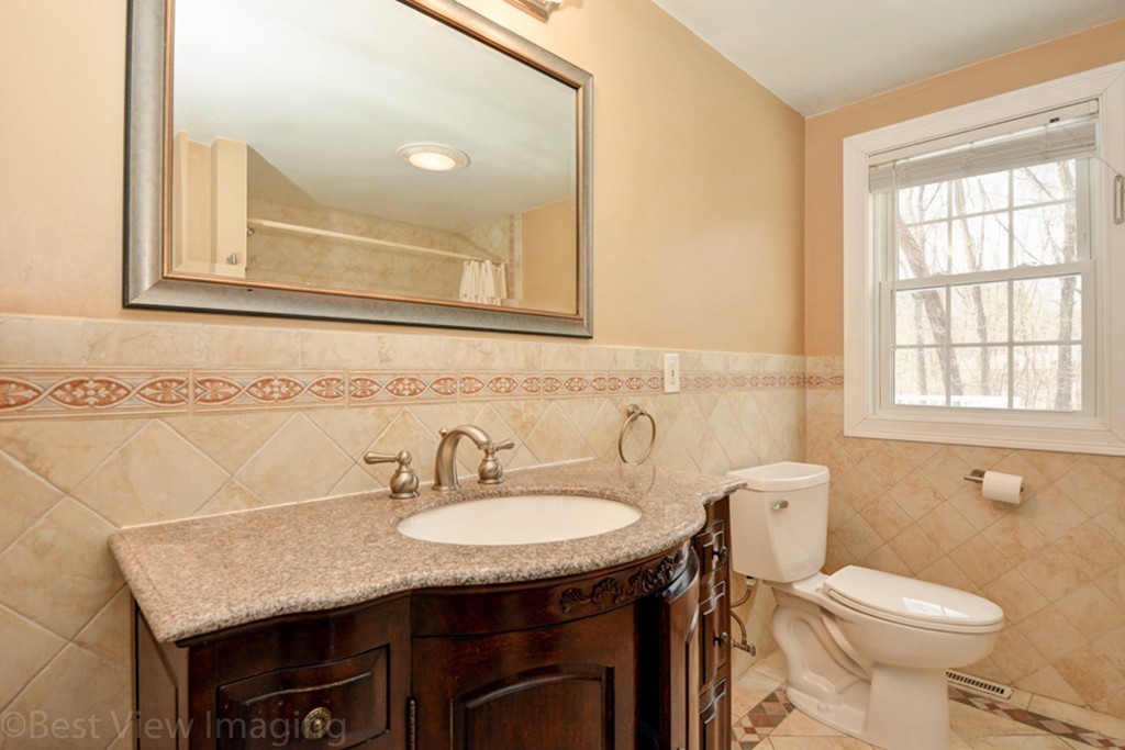 59 Amor Road Milton, MA 02186 - Photo 18 of 29 a bathroom with a granite countertop toilet sink and mirror