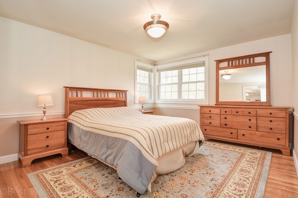59 Amor Road Milton, MA 02186 - Photo 19 of 29 a bedroom with a bed and window with mirror