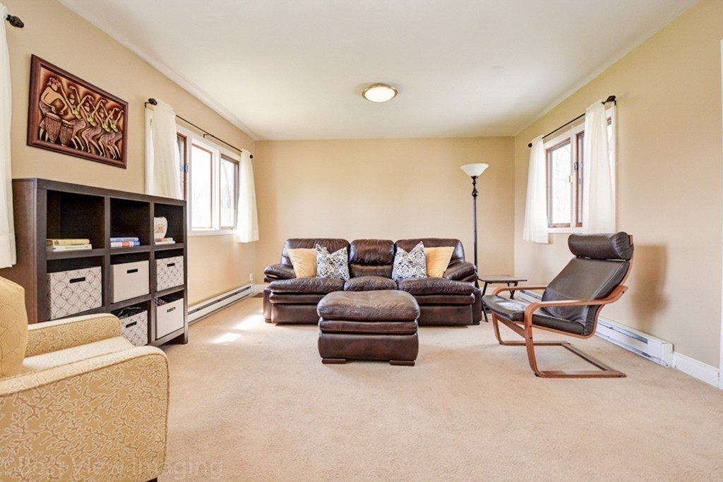 59 Amor Road Milton, MA 02186 - Photo 25 of 29 a living room with furniture and a flat screen tv