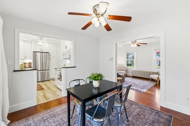 a living room with furniture a rug and a chandelier