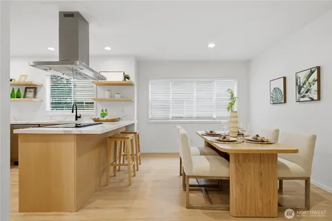 a kitchen with a table chairs stove and cabinets