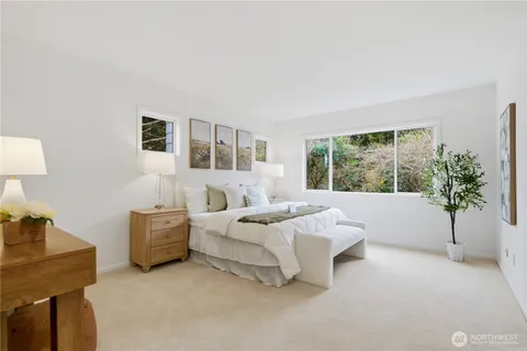 a bed room with a bed and a potted plant