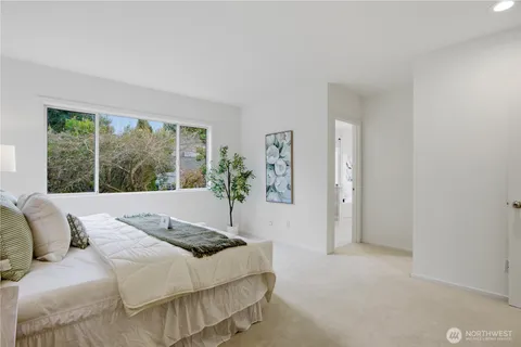 a bedroom with a bed and a large window