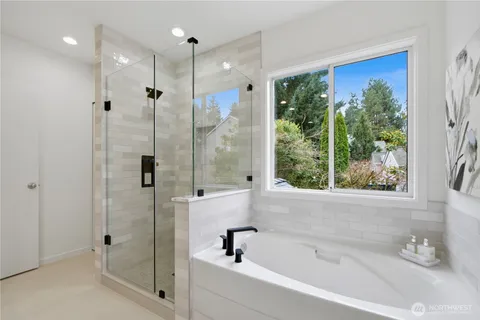 a bathroom with a bathtub and a shower