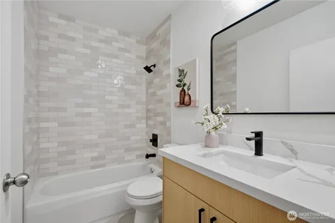 a bathroom with a sink mirror toilet and bathtub
