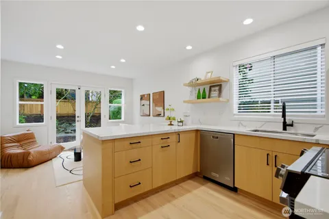 a view of a large kitchen with a sink and cabinets
