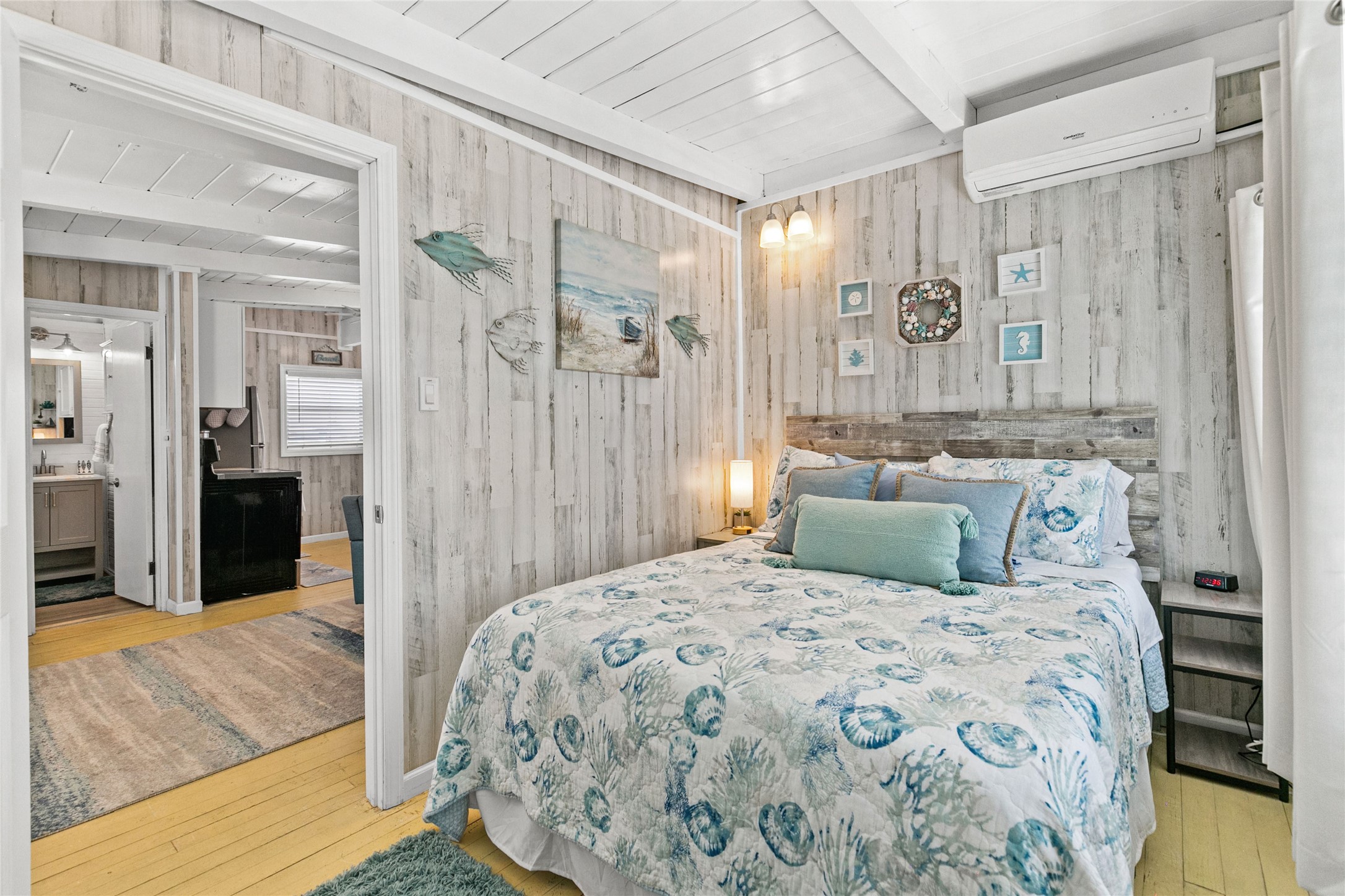 321 Pompano Lane Surfside Beach, TX 77541 - Photo 16 of 36 a bedroom with a large bed and a chandelier