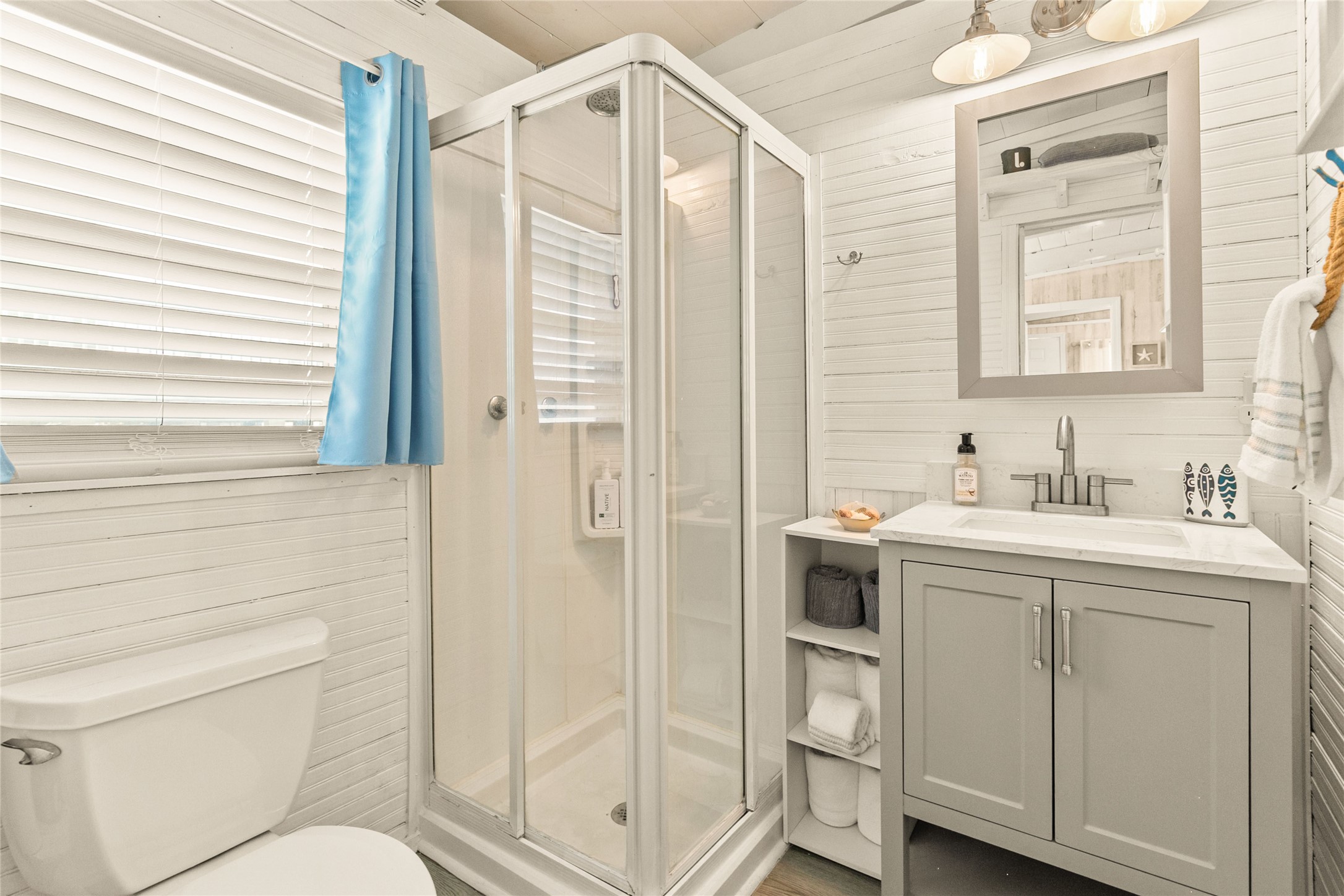 321 Pompano Lane Surfside Beach, TX 77541 - Photo 20 of 36 a bathroom with a sink a toilet and shower