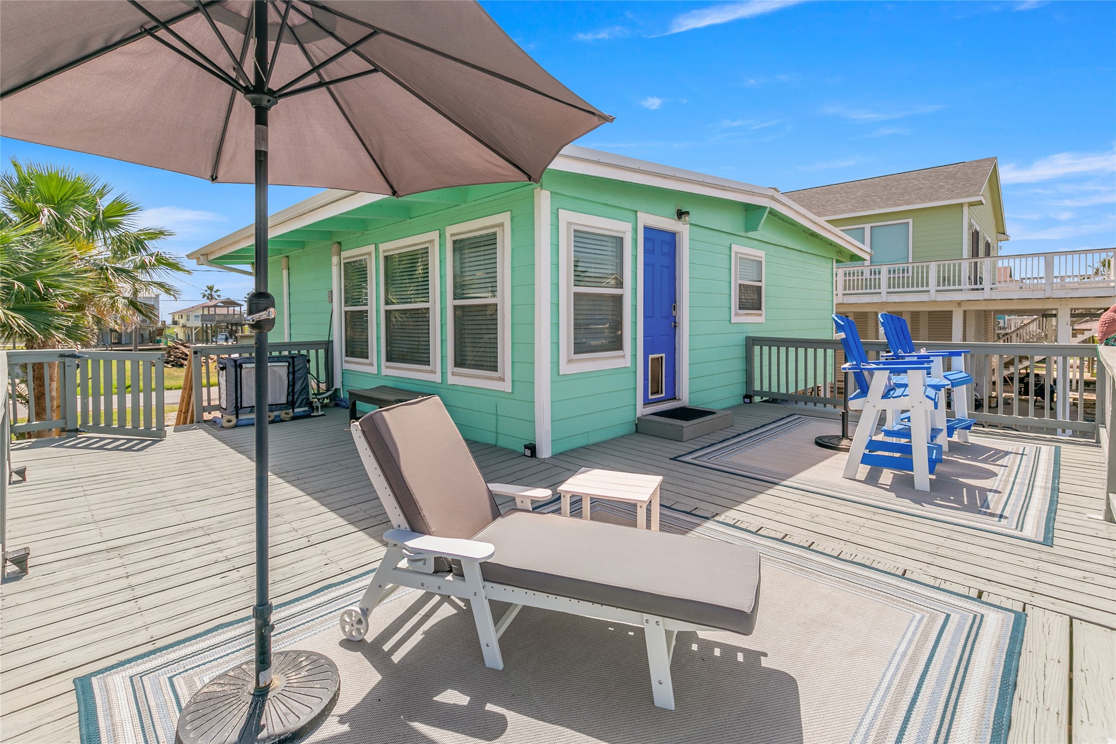 321 Pompano Lane Surfside Beach, TX 77541 - Photo 6 of 36 a view of a patio with a table and chairs under an umbrella