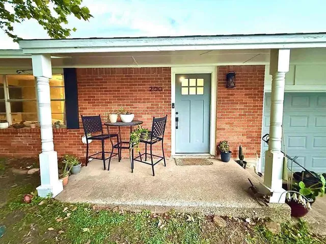 a view of a patio with table and chairs