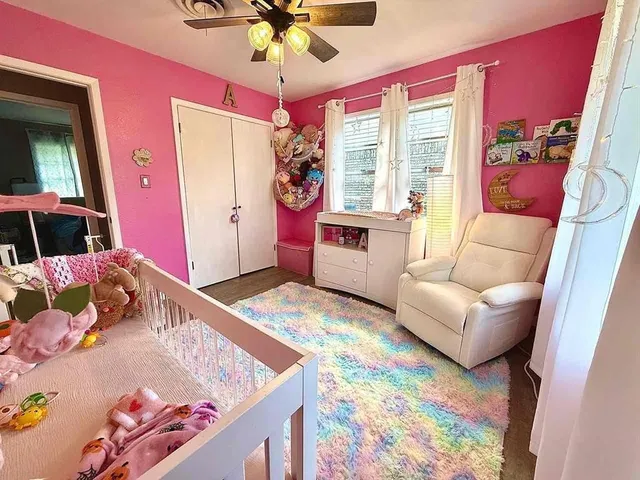 a bedroom with a bed a couch and dresser