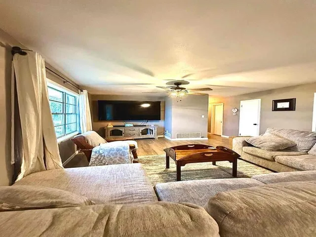 a bedroom with furniture and a large window