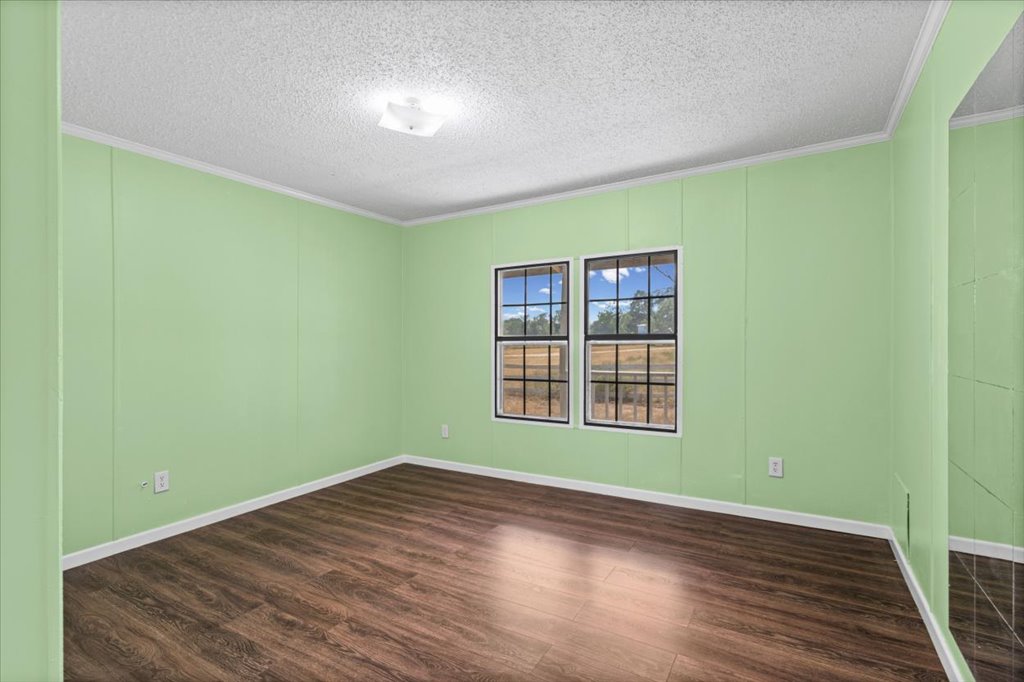 13501 Nutty Brown Road, Unit B Austin, TX 78737 - Photo 16 of 29 Laminate flooring and a wide window brighten this comfortable, quiet space.