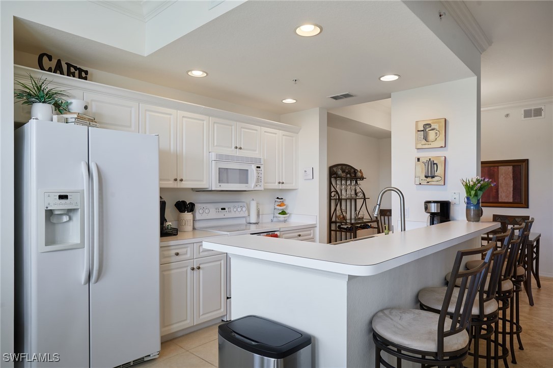 8550 Kingbird Loop, Unit 637 Estero, FL 33967 - Photo 19 of 35 a kitchen with stainless steel appliances a refrigerator sink and white cabinets