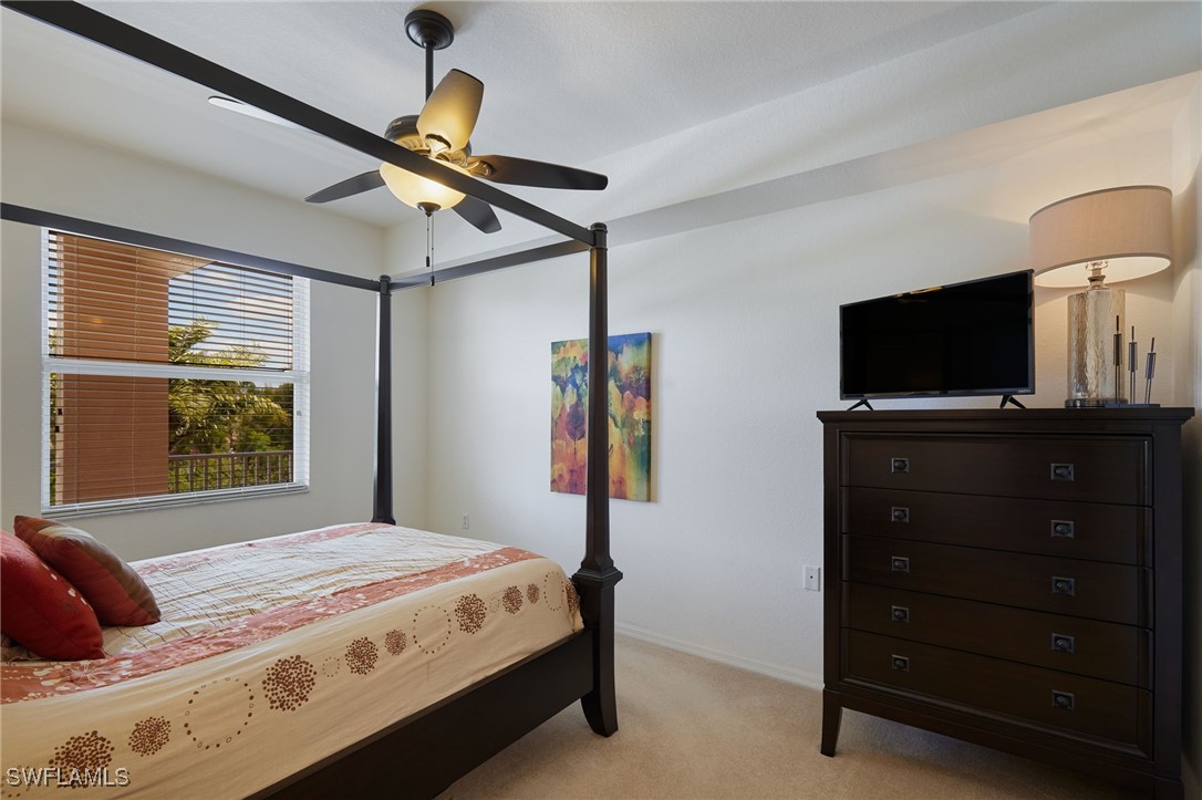 8550 Kingbird Loop, Unit 637 Estero, FL 33967 - Photo 22 of 35 a bedroom with a bed and a flat tv screen on a dresser