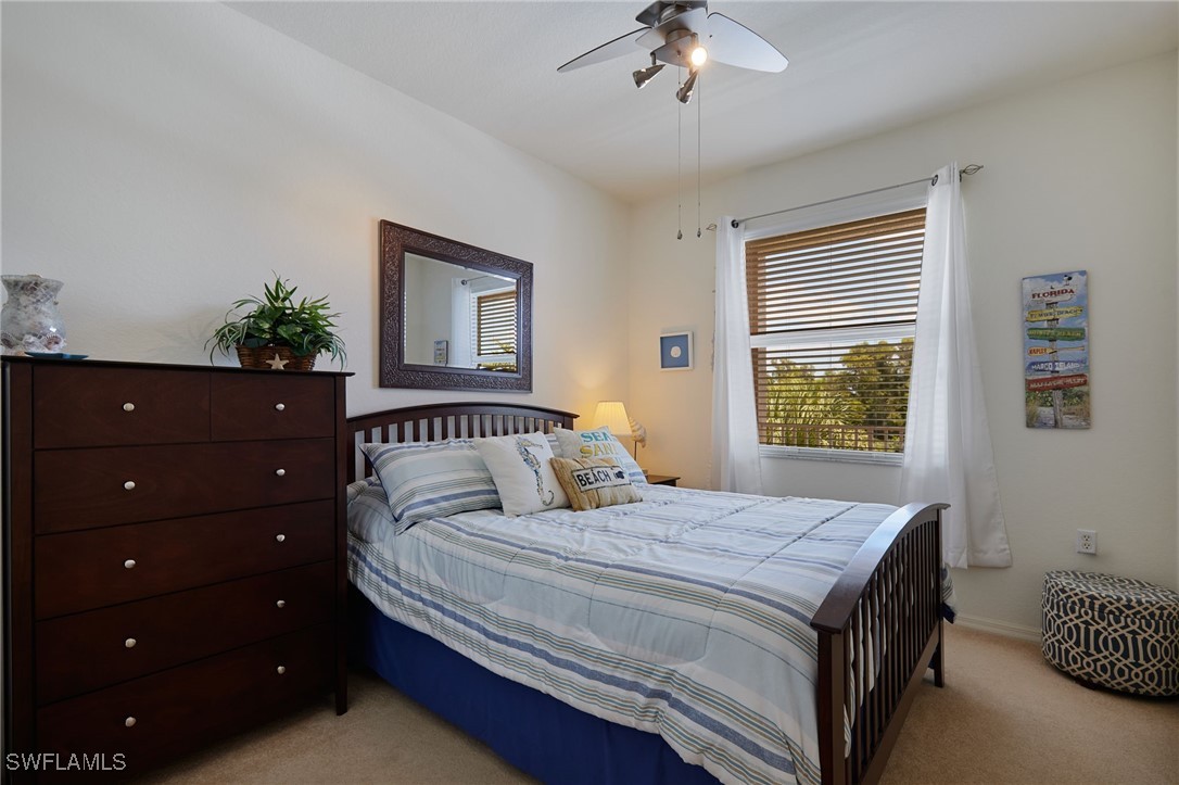 8550 Kingbird Loop, Unit 637 Estero, FL 33967 - Photo 24 of 35 a bedroom with a bed a window and potted plant on a dresser