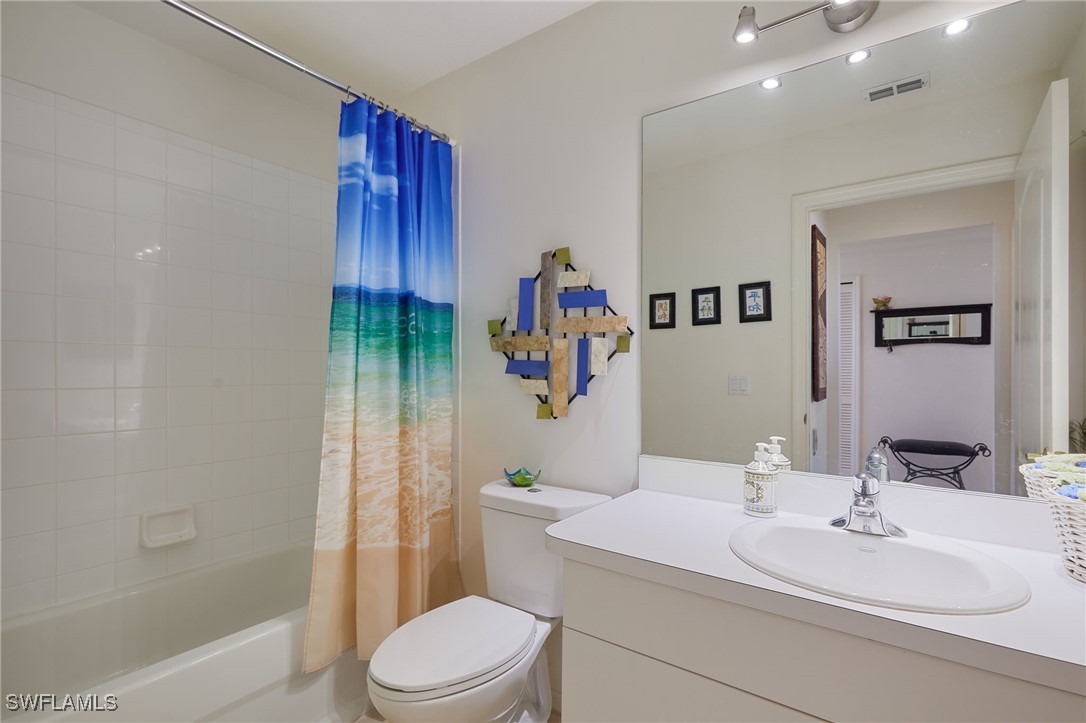 8550 Kingbird Loop, Unit 637 Estero, FL 33967 - Photo 25 of 35 a bathroom with a sink a toilet and shower
